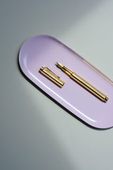 Caran d'Ache Ecridor Chevron fountain pen with an engraved barrel on a pink Lola stand.