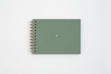Canvas photo album in green color. Finished with a copper spiral and a small heart in the center.