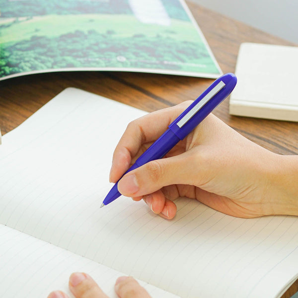 A blue Bullet ballpoint pen held in hand.