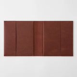 An open chocolate-colored paper cover in a square format.