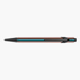 Black Caran d’Ache 849 Paul Smith ballpoint pen with colourful stripes and a black clip.