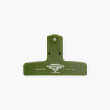 A green plastic paper clip with a light green logo featuring the Penco brand name.