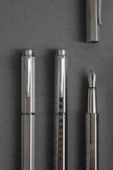 Premium Caran d'Ache fountain pens with engraved silver-colored barrels.