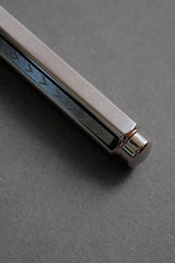Rear section of the Caran d'Ache Ecridor Chevron fountain pen with a V-shaped engraved pattern.