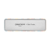 A silver metal tin with the inscription Caran d’Ache + Paul Smith.