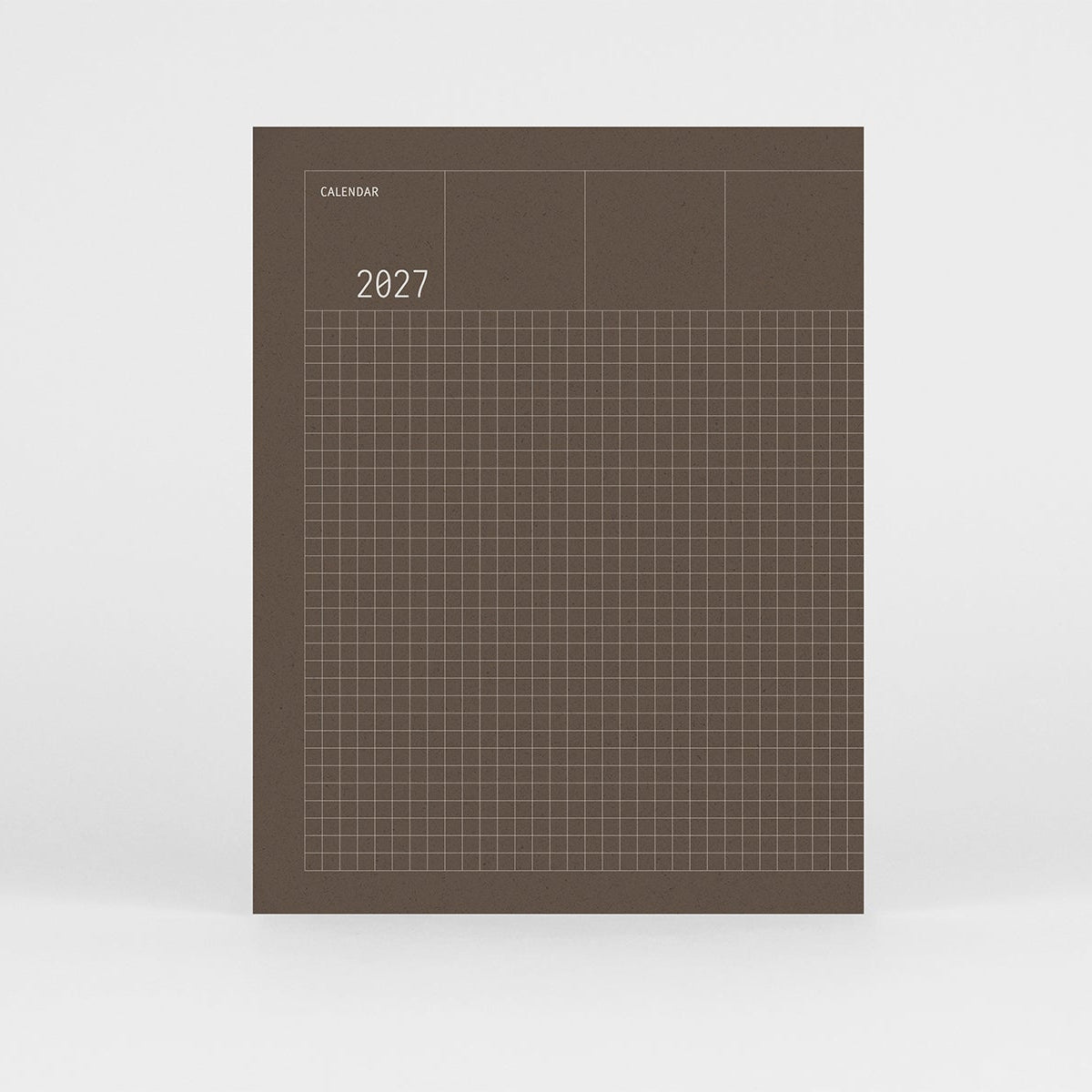 Kalendarz Grid na 2027 rok w kolorze brązowym i srebrnym wzorem w kratkę na okładce.