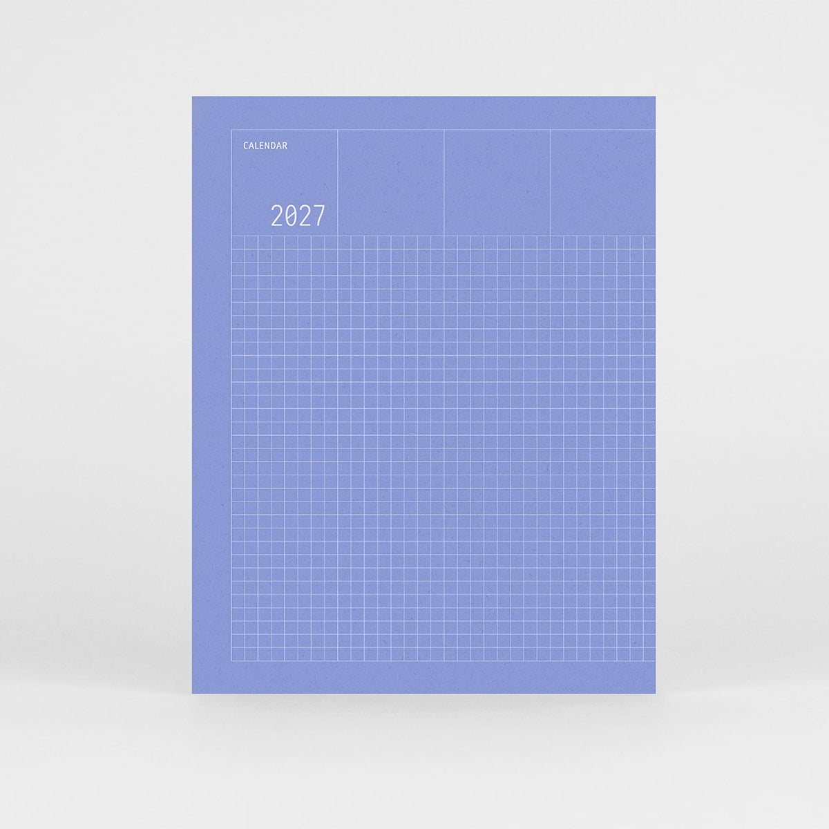 Kalendarz Grid na 2027 rok w kolorze niebieskiem i srebrnym wzorem w kratkę na okładce.