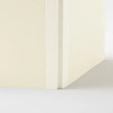 Sewn spine of a cream-colored notebook from the MD Product series by the Midori brand.