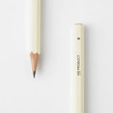 A cream-colored sharpened pencil with a black MD Product inscription and a hardness marking of B.