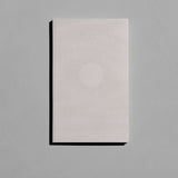 Beige Luna notebook in a soft cover with a white dotted full moon pattern and silver speckles.