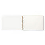 The cream-colored interior of a spiral-bound Penco sketchbook.