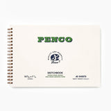 A cream-colored sketchbook with a metal spiral binding, featuring green lettering with the Penco brand name and smaller text containing information about the sketchbook.