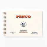 A cream-colored sketchbook with a metal spiral binding, featuring red lettering with the Penco brand name and smaller text containing information about the sketchbook.